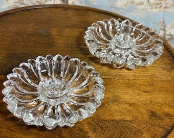 A pair of clear vintage pressed glass taper candle holders with floral design hazel atlas