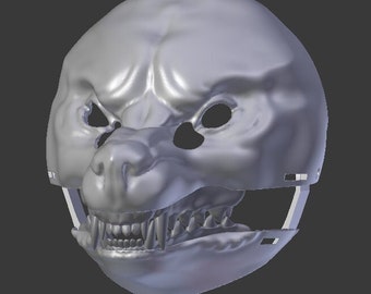 May include: A gray 3D model of a wolf or dog mask with a detailed snout and teeth. The mask is designed to be worn and has a strap on the back.