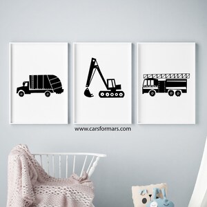 May include: Three black and white illustrations of vehicles on white backgrounds. The illustrations are of a garbage truck, an excavator, and a fire truck. The illustrations are framed and hung on a light gray wall.