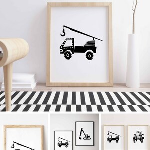 May include: Black and white printable art prints featuring illustrations of construction vehicles. The prints show a crane truck, an excavator, and a jeep. The prints are framed in simple wooden frames.