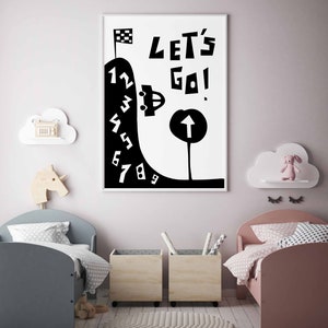 May include: Black and white illustration of a car driving up a hill with numbers 1 through 9. The text "Let's Go!" is above the car. The illustration is framed and hanging on a wall in a child's room.