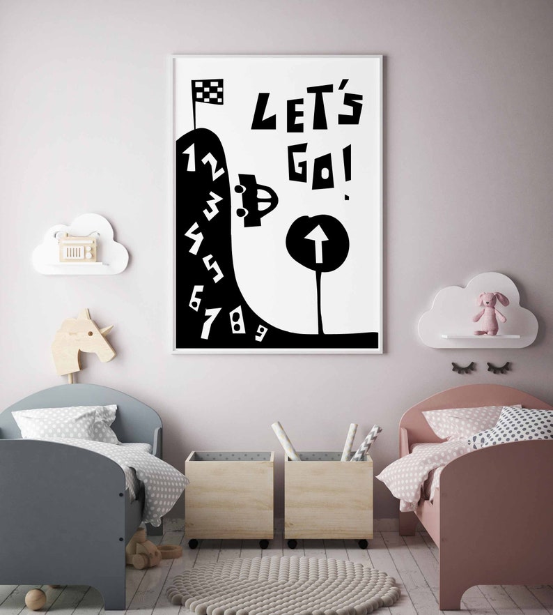 May include: Black and white illustration of a car driving up a hill with numbers 1 through 9. The text "Let's Go!" is above the car. The illustration is framed and hanging on a wall in a child's room.