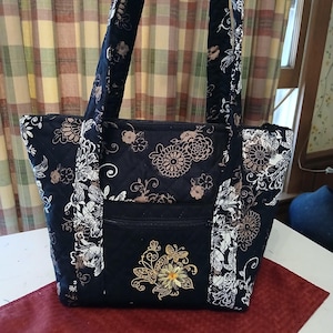 2 strap quilted purse, 10 pockets, makeup pouch included, emb. design butterflys