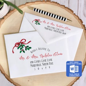 May include: White envelope with a red and green holly design and the text "KINDLY DELIVER TO: Mr. & Mrs. Nicholas Claus 1218 CANDY CANE LANE MERRYVILLE. NORTH POLE 30429" printed on it.