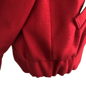 May include: Red fleece jacket with a ribbed hem.