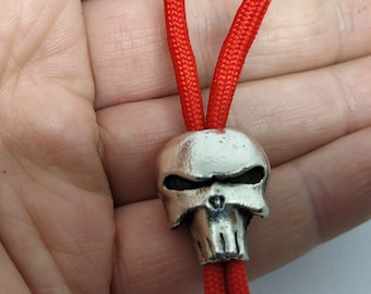 Handmade Punisher skull bead in solid pewter. Perfect for paracord, lanyards, knives, keychains, and biker DIY projects. Sold in sets