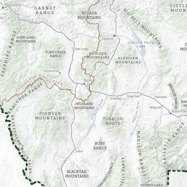 May include: A detailed map of a mountainous region, with names of mountain ranges, cities, and rivers. The map uses a neutral colour palette with brown, grey, and green tones, and includes the Continental Divide Trail.