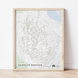 May include: A black and white topographic map of Galbraith Mountain, a popular hiking and mountain biking destination in Washington state. The map shows trails, elevation contours, and points of interest. The map is framed in a light wood frame.