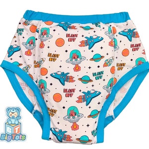 May include: White training pants with a blue trim and a space-themed print featuring rockets, planets, and the words "Blast Off".