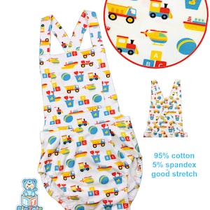 May include: White baby romper with a colorful print of trucks, trains, boats, and ABC blocks. The romper has a round neckline, shoulder straps, and a comfortable fit. The fabric is 95% cotton and 5% spandex.