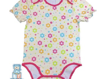 May include: A baby bodysuit with a floral pattern. The bodysuit is cream-colored with a repeating pattern of colorful flowers in pink, blue, yellow, and green. The edges are trimmed in bright pink.