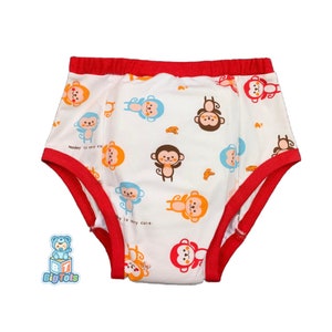 May include: White training pants with a red trim and a monkey print. The text "Monkey is very cute" is printed on the pants.