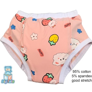 May include: Pink baby underwear featuring a pattern of strawberries, clouds, flowers, and the word "happy". The underwear has white trim and the text "95% cotton 5% spandex good stretch".