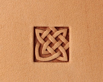 May include: A close-up of a leather surface with a carved Celtic knot design.