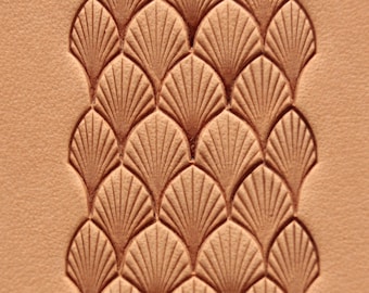 May include: A close-up of a light brown leather surface with a decorative pattern of overlapping fan shapes embossed into the leather.