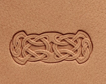 May include: A close-up of a leather surface with a detailed Celtic knot design embossed into the material.