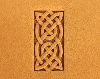 May include: A brown leather background with a carved Celtic knot design in the centre. The knot is a traditional symbol of strength and unity.