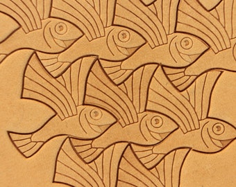 May include: A tan leather background with a repeating pattern of stylized fish carved into the surface. The fish are facing different directions and have a detailed design with lines and curves.
