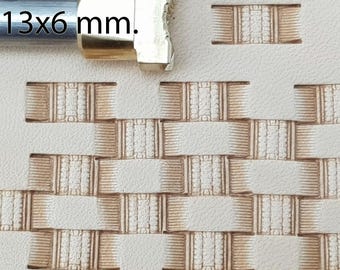 May include: A leathercraft tool with the text "№ 158" and "13x6 mm." is shown next to a stamped leather pattern. The pattern is a repeating woven design in shades of brown on a cream-colored background. The tool is made of metal.
