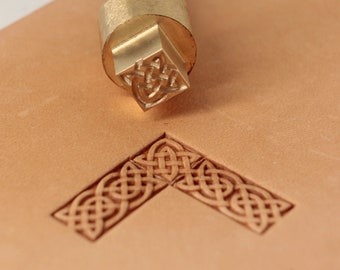 May include: A brass leather stamping tool with a Celtic knot design. The tool is shown stamping the design into a piece of leather.