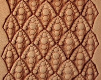 May include: Close-up of a leather surface with a textured pattern of overlapping circles, creating a unique and intricate design.