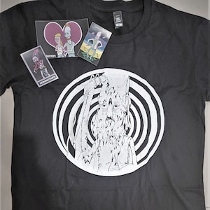 May include: Black t-shirt with a white graphic of a creature with a long beard and a spiral pattern behind it. The shirt has a tag that says "Demonstrips".