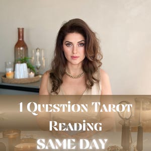 May include: A woman with long brown hair and a gold chain necklace is seated at a table. The text overlay reads "1 Question Tarot Reading Same Day". Candles and decorative items are on the table.