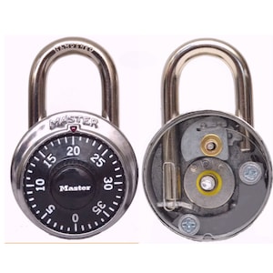 May include: A silver combination padlock with a black dial numbered 0 to 35. The padlock is open and the internal mechanism is visible.