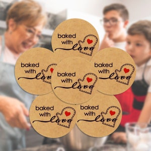 May include: Six round brown paper stickers with the text "baked with love" and a red heart in a mitten design.
