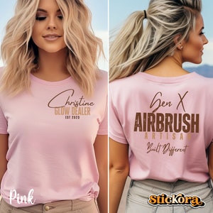 May include: Pink t-shirt with the text "Christine Glow Dealer Est 2023" on the front and "Gen X Airbrush Artisan Built Different" on the back.