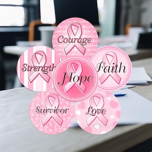 May include: Six pink and white round stickers with pink ribbons and words: Strength, Courage, Hope, Faith, Survivor, Love.