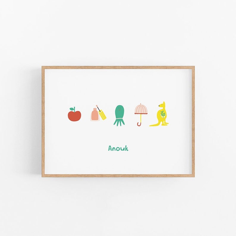 May include: A framed print with a white background and colorful illustrations of an apple, a bottle of nail polish, an octopus, an umbrella, and a kangaroo. The text "Anouk" is printed below the illustrations.