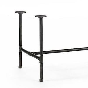May include: Black industrial pipe table legs. The legs are made of metal pipes and fittings, with a dark finish. The design includes two vertical supports with round mounting plates and a horizontal support.