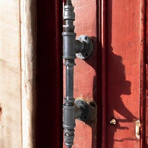 May include: A set of three ceramic mugs with a speckled, matte finish. The mugs are in shades of cream, light gray, and dark gray. Each mug has a simple, minimalist design, perfect for coffee or tea.