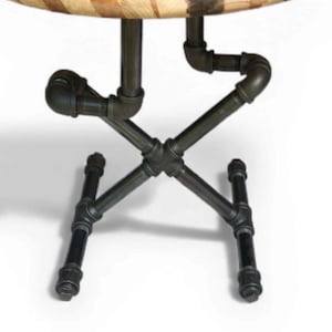 May include: A round table with a wooden top and a metal pipe base. The tabletop is made of light and dark wood pieces arranged in a circular pattern. The base is constructed from black metal pipes and fittings.