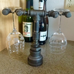 Wine glass stand crafted from industrial iron pipes, designed to hold two wine glasses