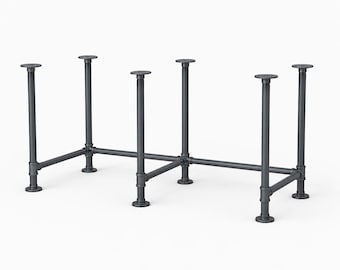May include: A dark gray metal table base constructed from industrial pipes and circular floor flanges. The frame features six vertical support columns connected by horizontal pipe segments, creating a sturdy rectangular structure for a tabletop.