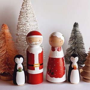 Santa, Mrs. Claus and penguins wooden peg dolls
