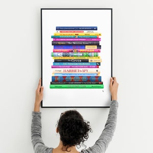 May include: A framed print of a stack of colorful books, including titles like "The Giver", "Matilda", "The Phantom Tollbooth", and "Harriet the Spy".