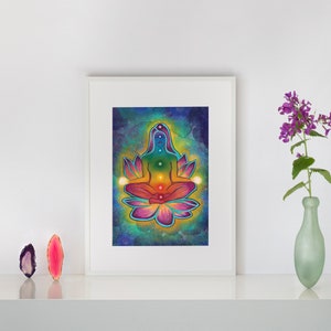 May include: A colorful illustration of a person meditating in a lotus position with seven chakras represented by different colors. The background is a dark blue with stars and a light blue and green watercolor effect.
