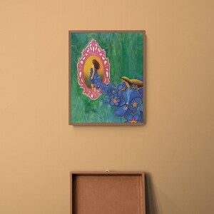 May include: A framed painting of a woman in a blue dress standing in a pink ornate frame, surrounded by blue flowers and a small bird. The painting is on a green background.