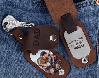 May include: Brown leather keychains with a silver key, a photo of a couple, and a metal tag that says "Drive safe. I love you Alicia" with a heart symbol.
