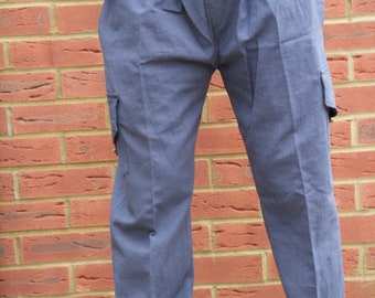 May include: A pair of blue cargo trousers with elasticated cuffs. The trousers have two large pockets on the sides.