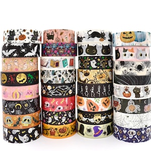 May include: A collection of decorative washi tape rolls featuring various Halloween-themed patterns including black cats, pumpkins, skulls, ghosts, bats, spiders, webs, and books. The rolls are stacked in four columns against a white background.