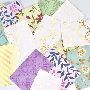 Peut inclure: Un ensemble de cartes d&eacute;coratives avec diff&eacute;rents motifs et des accents dor&eacute;s. Les cartes pr&eacute;sentent des motifs floraux, des formes g&eacute;om&eacute;triques et des rayures.