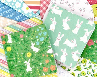May include: A collection of square and circular paper cards featuring various patterns including white rabbits on green backgrounds, floral prints, colorful stripes, pink gingham, and polka dots in shades of green, pink, yellow, and blue.