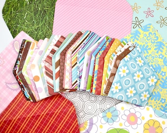 May include: A collection of small paper envelopes featuring a variety of colorful patterns including floral, plaid, striped, polka dot, and geometric designs. The envelopes are arranged in a fan shape, displaying diverse prints and colors.