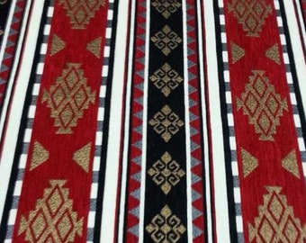 May include: Red, white and black striped fabric with a geometric pattern in gold. The pattern is a repeating design of diamonds and squares.