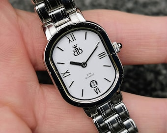 Reloj de cuarzo Brooks & Bentley con esfera rectangular blanca y fecha, pulsera de acero pulido