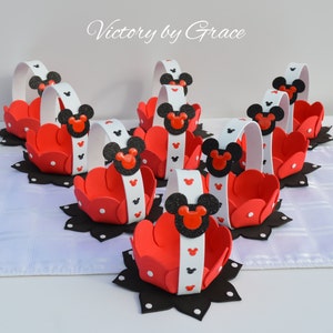 May include: Eight red and black Mickey Mouse themed party favor baskets with white handles and black polka dots. The baskets are made of foam and have a Mickey Mouse head design on the front.